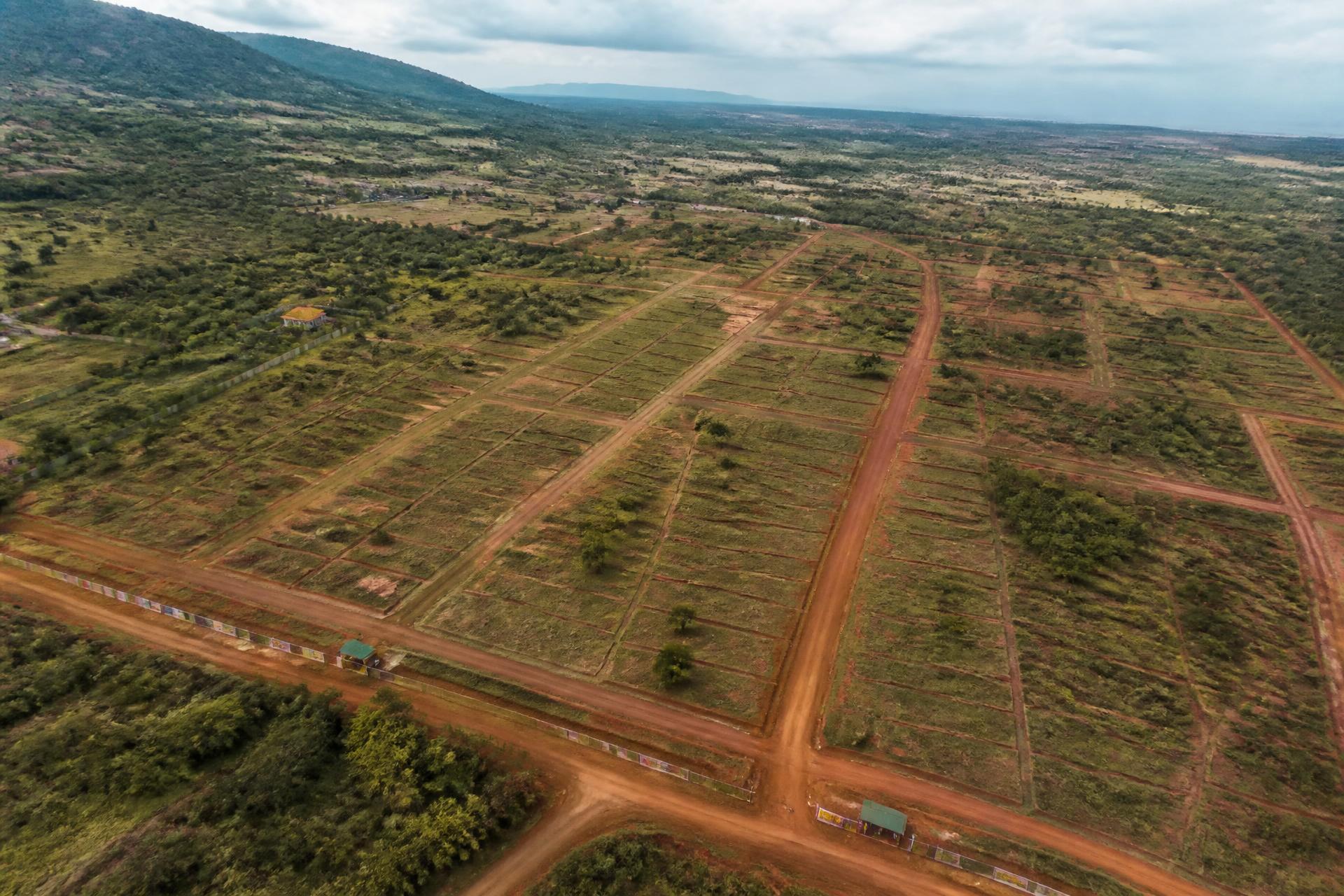 Aerial view of a subdivided development site and surrounding terrain
